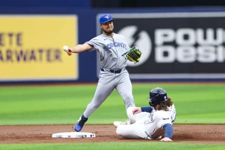 Toronto Blue Jays second baseman Lenyn Sosa (50) turns a double play against the Tampa Bay Rays in the first inning at Tropicana Field.