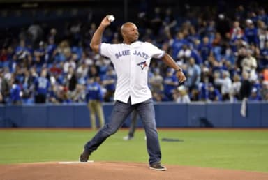 Toronto Blue Jays former player Vernon Wells throws out the ceremonial first pitch before the game against the Kansas City Royals in game five of the ALCS at Rogers Centre.
