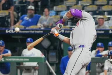 Arizona Diamondbacks left fielder Lourdes Gurriel Jr. (12) hits a one-run triple against the Kansas City Royals during the eleventh inning at Kauffman Stadium.