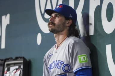Toronto Blue Jays pitcher Dylan Cease (84) sits in the dugout after being relieved in the third inning after pitching 2 2/3 innings, with six walks and three strike outs against the Texas Rangers at Globe Life Field.