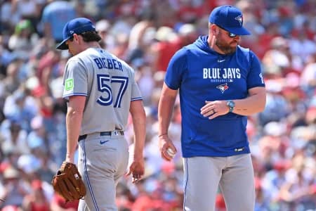 Toronto Blue Jays manager John Schneider (14) take the ball from pitcher Shane Bieber (57) against the Philadelphia Phillies during the sixth inning at Citizens Bank Park.