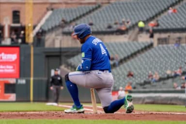 Toronto Blue Jays designated hitter George Springer (4) takes a knee after swinging at a strike during the first inning at Oriole Park at Camden Yards