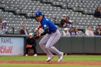 Toronto Blue Jays infielder Kazuma Okamoto (7) fields a ground ball during the seventh inning at Oriole Park at Camden Yards.