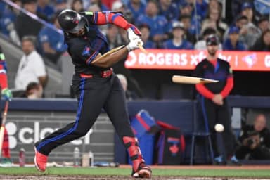 Toronto Blue Jays first baseman Vladimir Guerrero Jr. (27) breaks his bat as he hits a single against the Cincinnati Reds in the seventh inning at Rogers Centre.