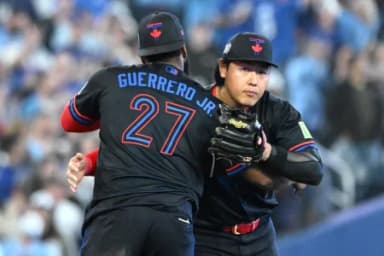 Toronto Blue Jays third baseman Kazuma Okamoto (7) celebrates with first baseman Vladimir Guerrero Jr. (27) after a win over the Cincinnati Reds at Rogers Centre.