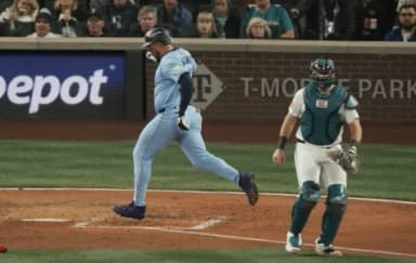 Toronto Blue Jays right fielder Anthony Santander (25) scores in the fifth inning behind Seattle Mariners catcher Cal Raleigh (29) during game three of the ALCS round for the 2025 MLB playoffs at T-Mobile Park.