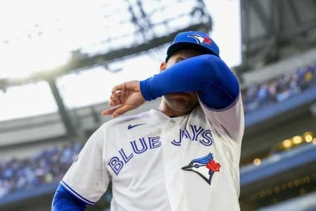 Toronto Blue Jays designated hitter George Springer (4) wipes tears away after playing his final MLB game against the Cincinnati Reds at Rogers Centre