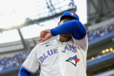 Toronto Blue Jays designated hitter George Springer (4) wipes tears away after playing his final MLB game against the Cincinnati Reds at Rogers Centre