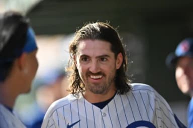 Chicago Cubs pitcher Kevin Gausman (12) smiles in the dugout against the Miami Marlins during the first inning at Wrigley Field