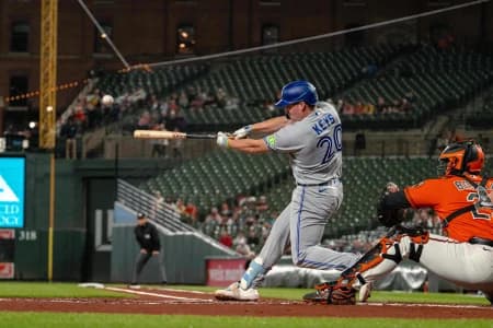 Toronto Blue Jays designated hitter Sean Keys (20) hits a sacrifice fly during the first inning at Oriole Park at Camden Yards.