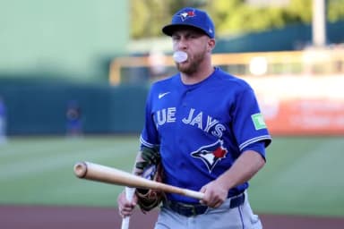 Toronto Blue Jays left fielder Myles Straw (3) walks toward the dugout while blowing a bubble with chewing gum and holding a bat before a game against the Athletics at Sutter Health Park