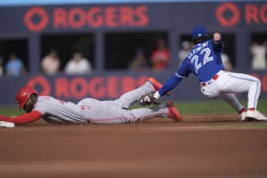 Toronto Blue Jays second baseman Ernie Clement (22) catches Cincinnati Reds right fielder Hector Rodriguez (43) trying to steal second base during the second inning at Rogers Centre.