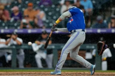 Toronto Blue Jays left fielder Whit Merrifield (15) hits an RBI single in the ninth inning against the Colorado Rockies at Coors Field.