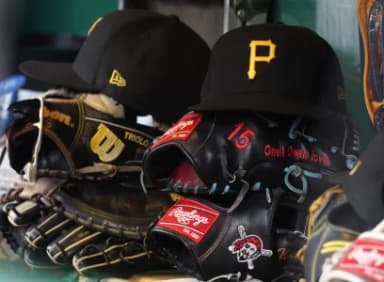Hats and gloves belonging to Pittsburgh Pirates infielder Jared Triolo (not pictured) and center fielder Oneil Cruz (not pictured) in the dugout during the seventh inning against the Kansas City Royals at PNC Park