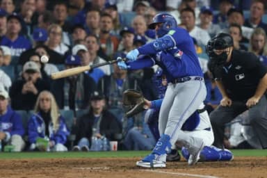 Toronto Blue Jays first baseman Ty France singles during the tenth inning against the Los Angeles Dodgers in game three of the 2025 MLB World Series at Dodger Stadium.