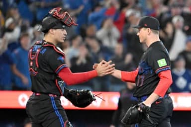 Toronto Blue Jays relief pitcher Louis Varland (77) shakes hands with catcher Brandon Valenzuela (59) after a win over the Cincinnati Reds at Rogers Centre.