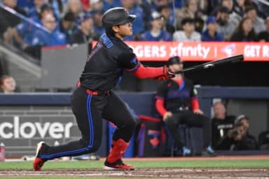 Toronto Blue Jays third baseman Kazuma Okamoto (7) hits a three RBI double against the Cincinnati Reds in the seventh inning at Rogers Centre.