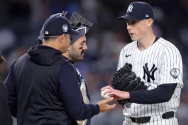 New York Yankees manager Aaron Boone (17) takes the ball from starting pitcher Ryan Yarbrough (33) during a pitching change during the third inning against the Baltimore Orioles at Yankee Stadium