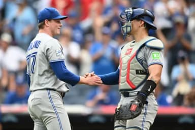 Toronto Blue Jays pitcher Louis Varland (77) celebrates with catcher Brandon Valenzuela (59) after the Blue Jays beat the Cleveland Guardians at Progressive Field.