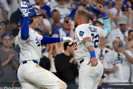 Los Angeles Dodgers first baseman Freddie Freeman (5) celebrates with second baseman Miguel Rojas (72) after hitting a home run during the fourth inning against the Atlanta Braves in game two of the NLDS for the 2026 MLB Playoffs at Uniqlo Field at Dodger Stadium.
