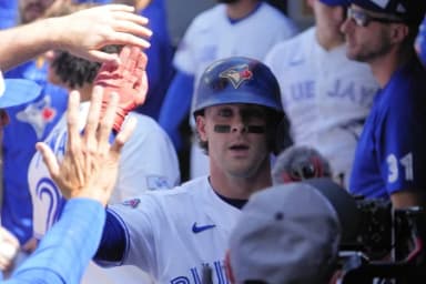 Toronto Blue Jays shortstop Ernie Clement (22) gets congratulated after scoring against the Tampa Bay Rays during the first inning at Rogers Centre.