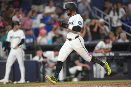 Miami Marlins second baseman Otto Lopez (6) scores a run against the Atlanta Braves in the seventh inning at loanDepot Park