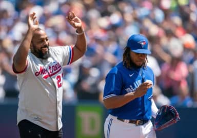 Montreal Expos former player Vladimir Guerrero Sr. acknowledges the crowd as Toronto Blue Jays designed hitter Vladimir Guerrero Jr. (27) looks at the first pitch ball against the Tampa Bay Rays at Rogers Centre