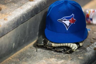 A view of a Toronto Blue Jays ball cap and logo during the game between the Texas Rangers and the Blue Jays at Globe Life Park in Arlington. The Blue Jays defeated the Texas Rangers 4-2.