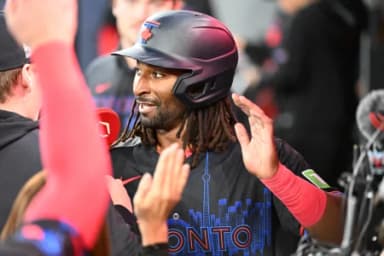 Toronto Blue Jays second baseman Charles McAdoo (26) celebrates with teammates in the dugout after scoring a run against the Cincinnati Reds in the first inning at Rogers Centre.